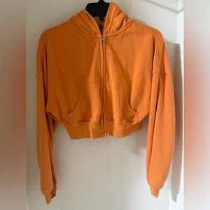 Divided Vibrant Orange Cropped Hoodie